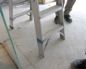 The legs of the metal ladder are not fitted with proper insulated footing