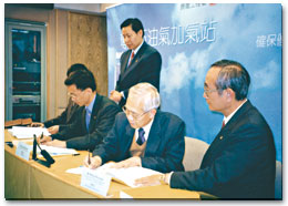 The Director of Electrical & Mechanical Services signs the contracts with the two contractors for the five new dedicated LPG filling Stations