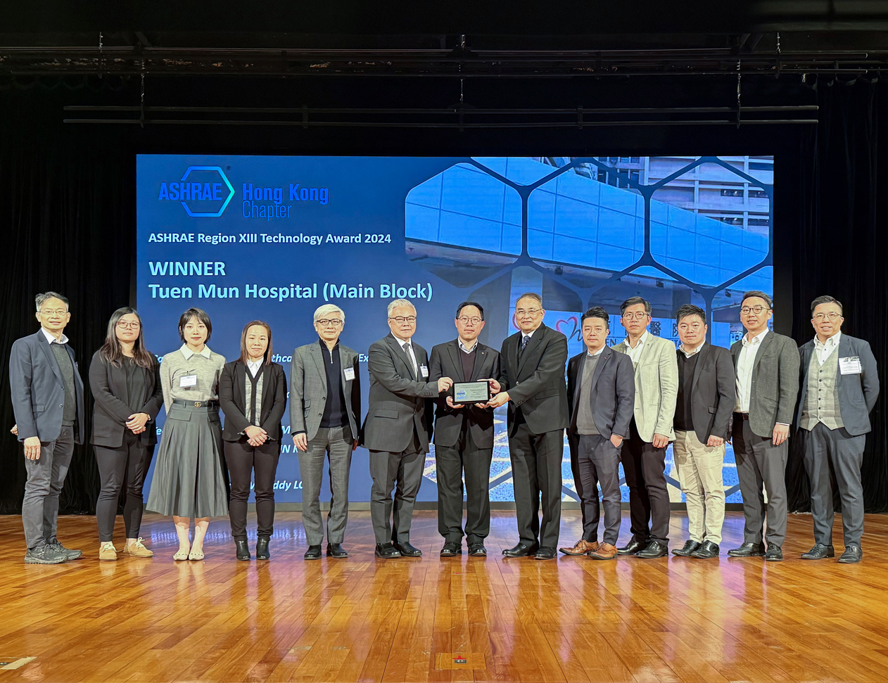 機電署與醫管局合作的屯門醫院高效能空調製冷機組更換工程項目，奪得ASHRAE第十三區2024年科技大獎（「醫療設施（現有）」組別）。機電署署長潘國英先生（左六）、機電署總工程師/衞生工程2黎錦輝先生（左七）及醫管局總項目經理（工程）源柏樑先生（右六）與同事出席頒獎典禮。